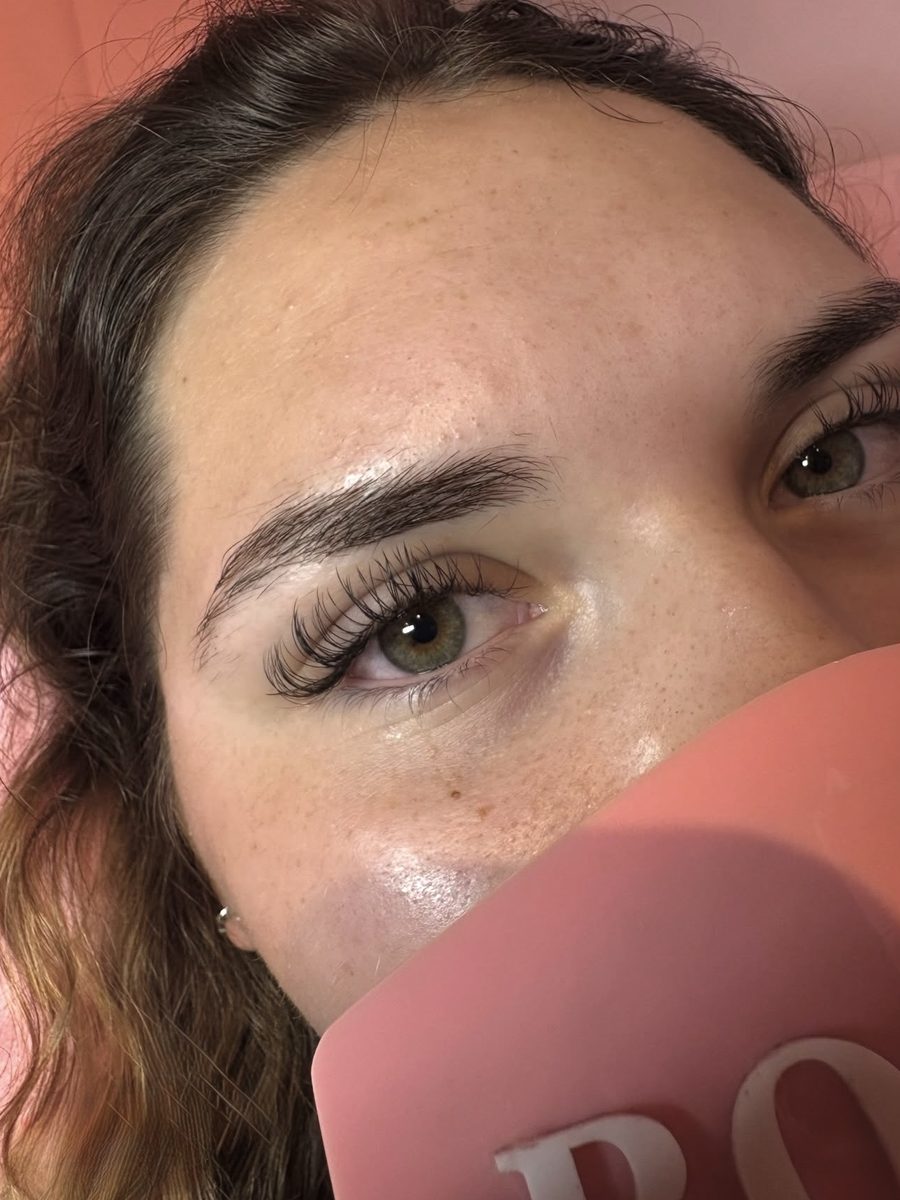 Close-up of a natural classic lash set with green eyes